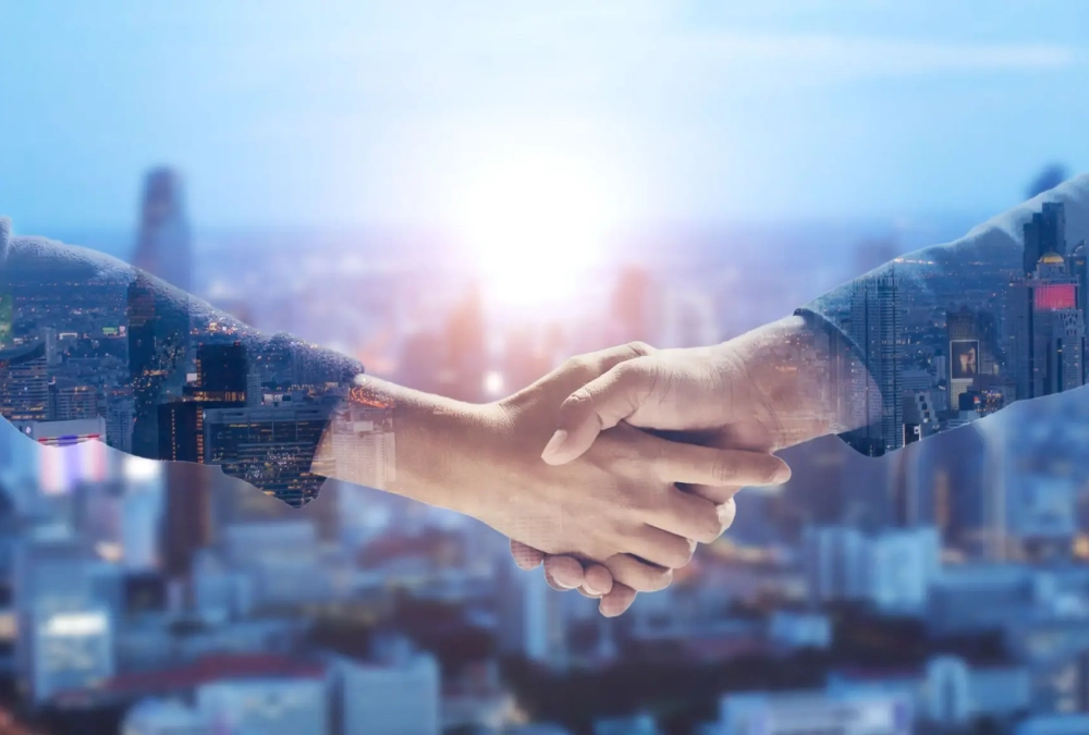 Two people shaking hands with a cityscape in the background.