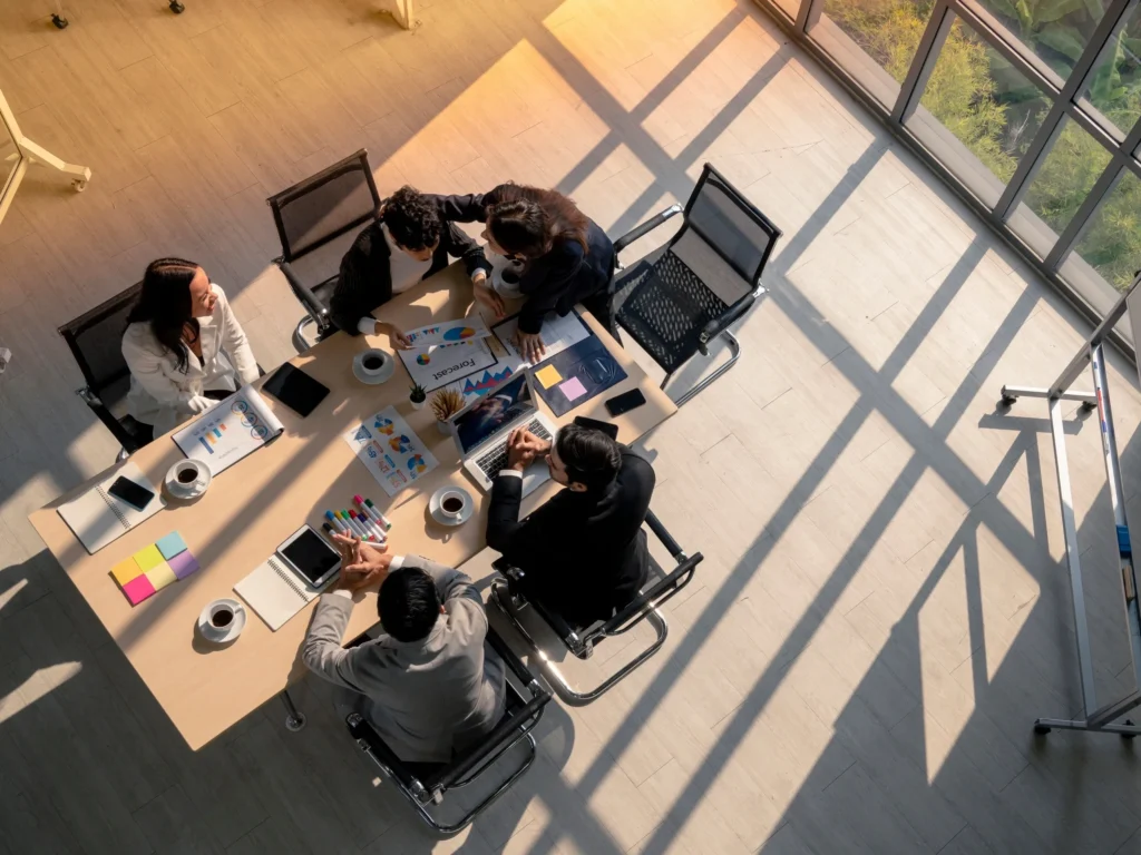 Business meeting in a sunlit conference room.