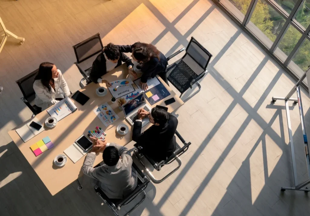 Business meeting in a sunlit conference room.